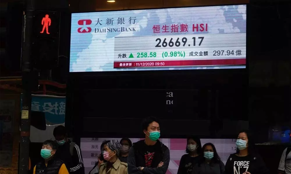 Asian markets mixed after Wall St falls on virus pressure