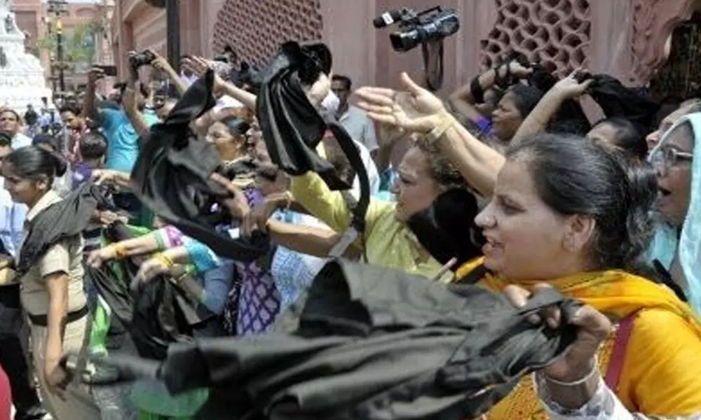 For women farmers, black flags priority over masks