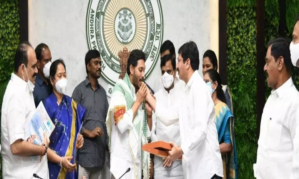 Chief Minister being greeted with sweets at Tadepalli camp office, near Vijayawada, on the occasion of completing two years in office by supporters on Sunday