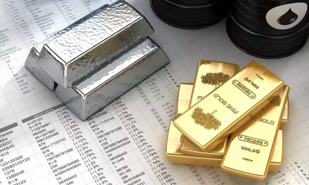 Silver tumbles by `505, gold marginally down