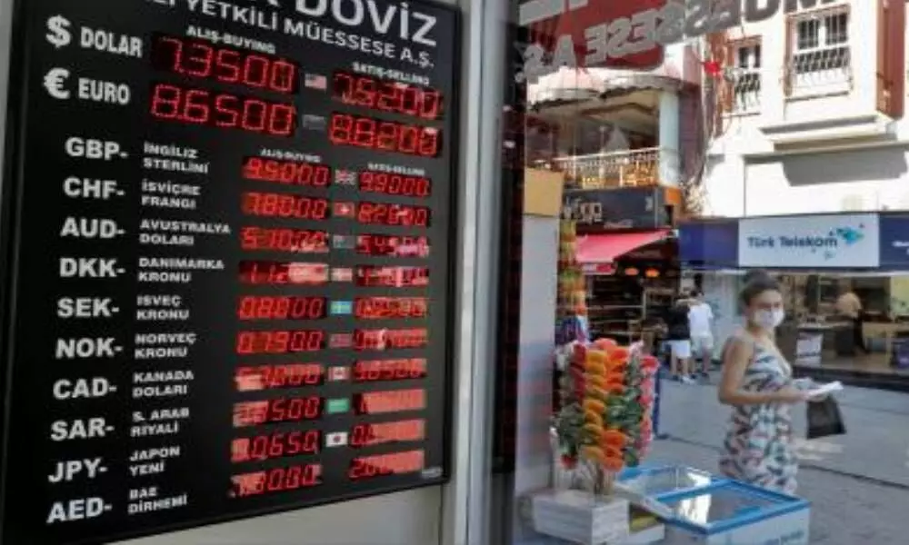 Turkey further cuts rates, lira dips to new record low