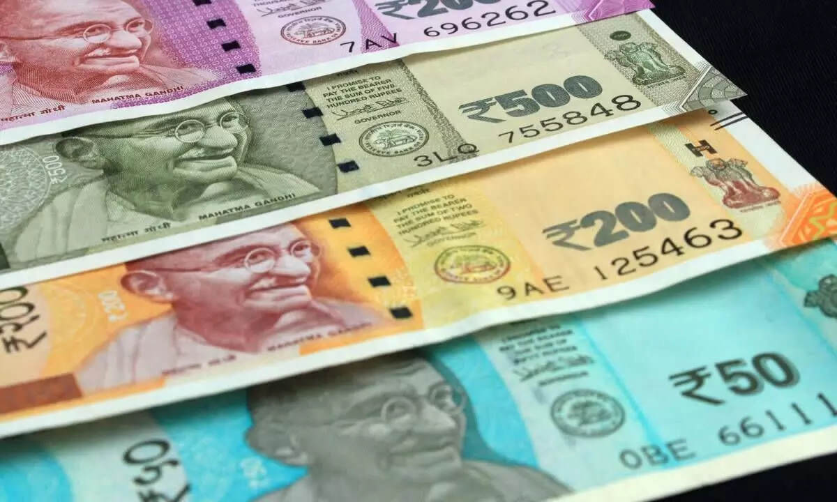 Rupee hits new low, falls 14 paise to 77.69 per US dollar