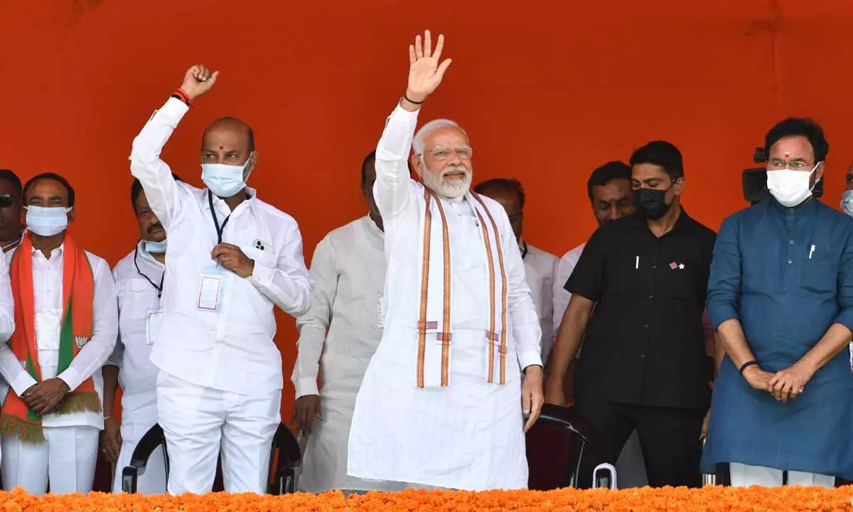 Prime Minister Narendra Modi waving to the gathering at the Begumpet Airport  where he addressing BJP party workers and leaders