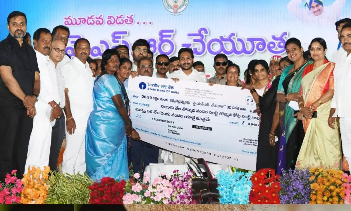 Chief Minister Y.S. Jagan Mohan Reddy handing over cheque for Rs 4,949 crore towards YSR Cheyutha scheme for third year in a row at Animganipalle near Kuppam on Friday
