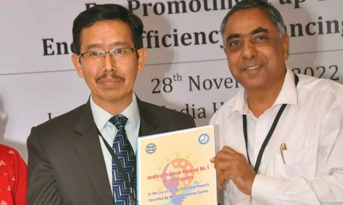 Deputy Director General of BEE, GoI, Ashok Kumar sharing a copy of the report on identified energy efficiency financing projects with A Chandrasekhara Reddy, CEO, APSECM, Energy dept, at the IT portal launch programme in Delhi