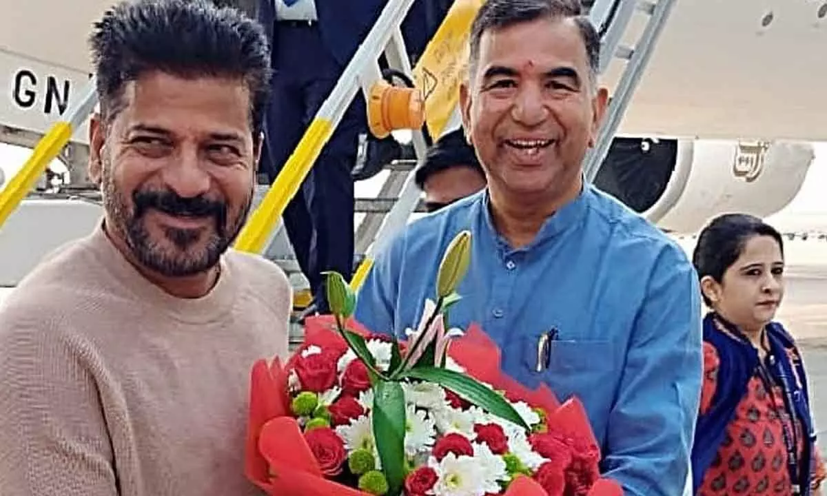 Congress leader H Venugopal Rao welcoming CM Revanth Reddy at the Rajiv Gandhi International Airport