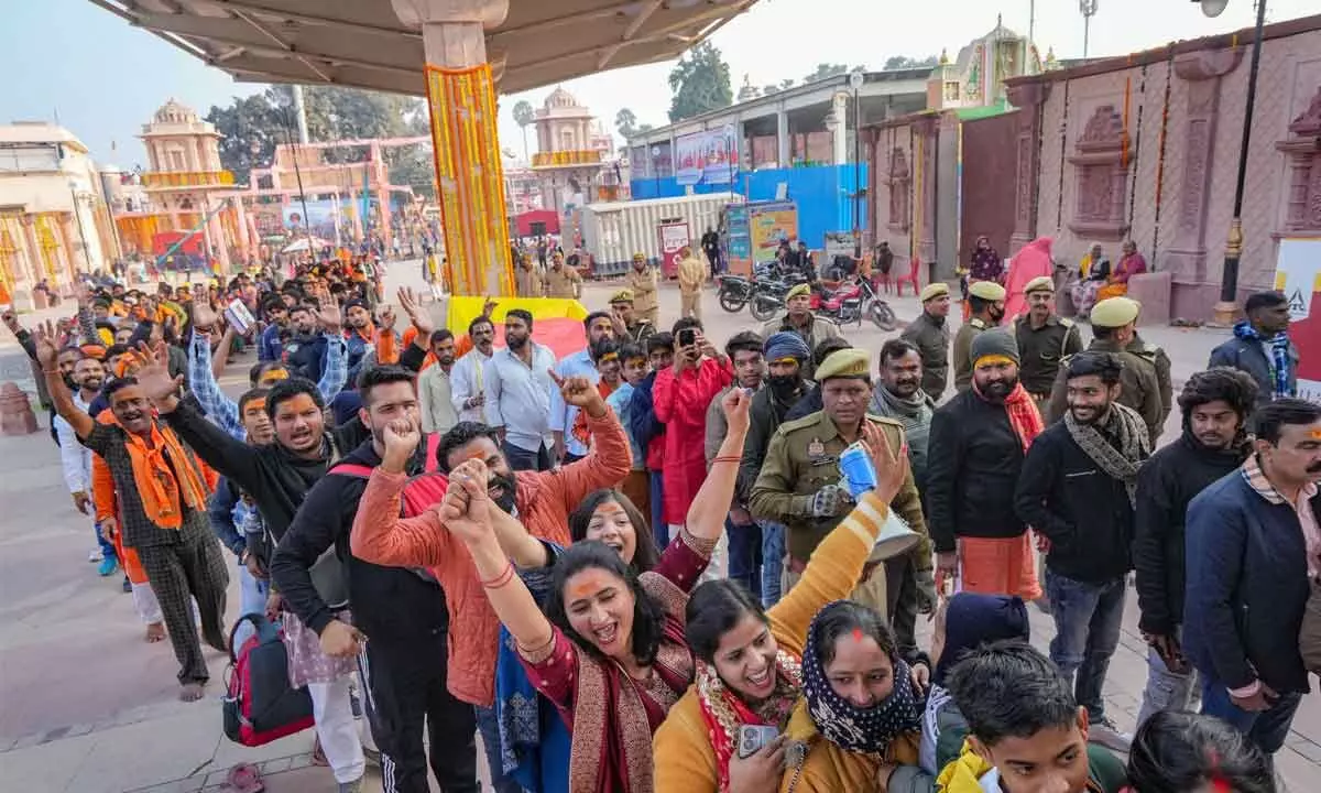 Devotees cheer as they wait in a queue to enter the Shri Ram mandir in Ayodhya on Tuesday as the doors of the temple opened to the general public a day after the consecration of the new Ram Lalla idol