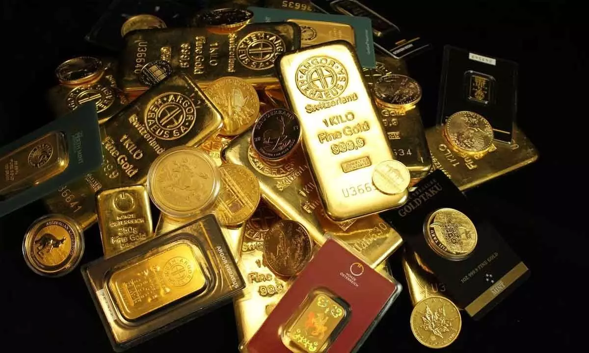 Gold futures rise on spot demand