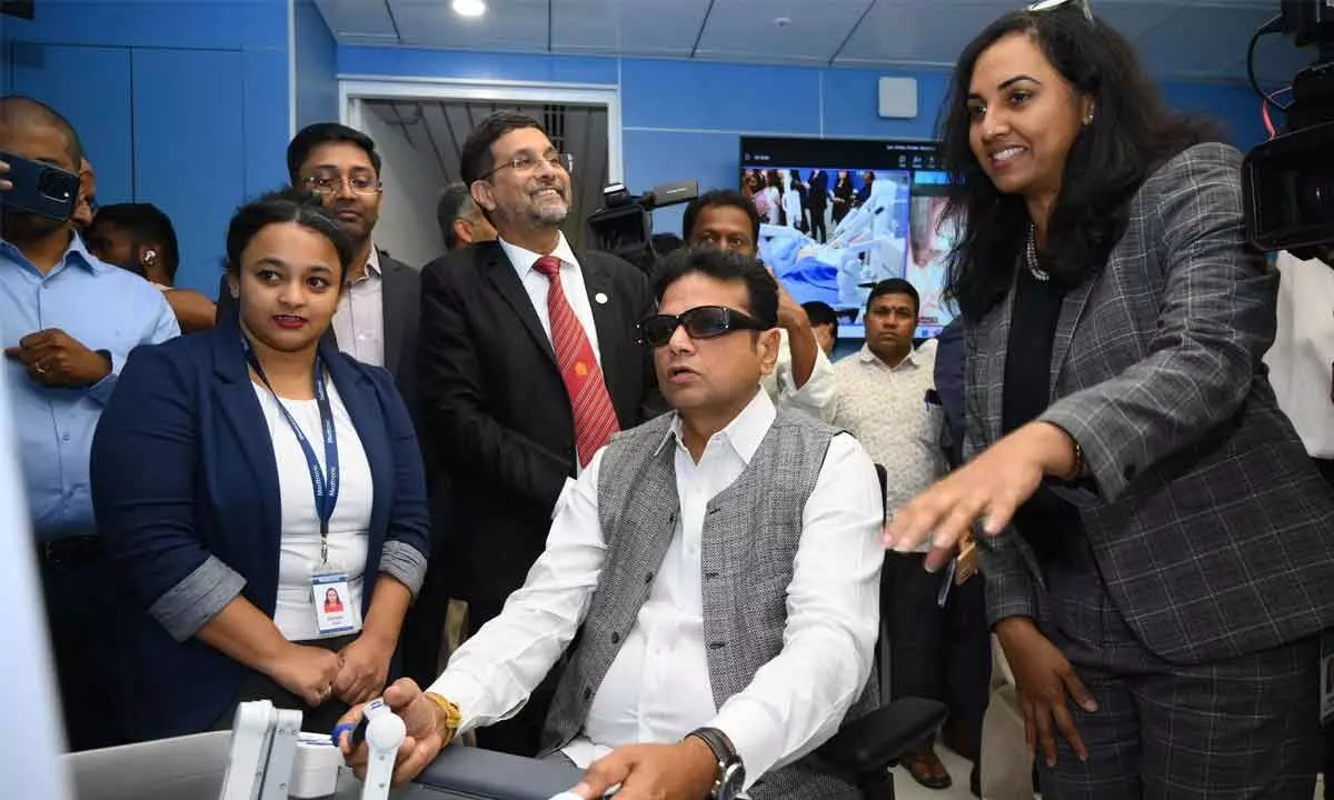 Telangana IT Minister D Sridhar Babu operating a robot at Medtronic Engineering and Innovation Center in Hyderabad on Thursday