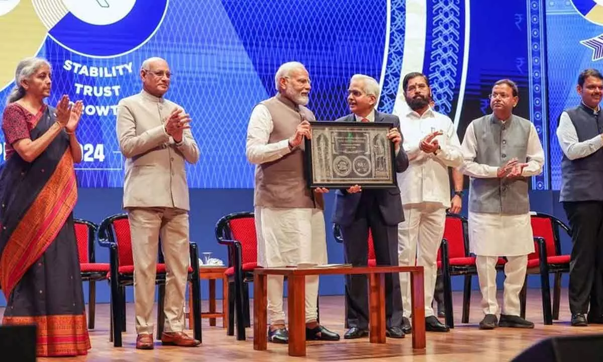 Prime Minister Narendra Modi receiving a memento from RBI Governor Shaktikanta Das during a ceremony marking 90 years of Reserve Bank of India, in Mumbai on Monday. Maharashtra Governor Ramesh Bais, Finance Minister Nirmala Sitharaman, Chief Minister Eknath Shinde, MoS for Finance Pankaj Chaudhary, and Deputy CM Devendra Fadnavis are also seen