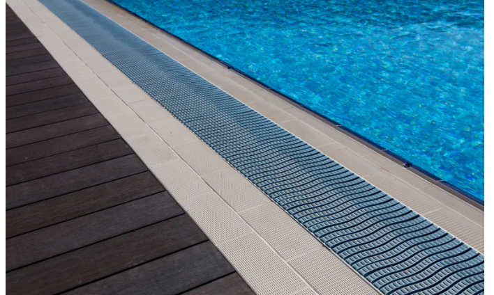 How Trench Drains Can Improve Drainage Around Pools, Driveways, and Patios